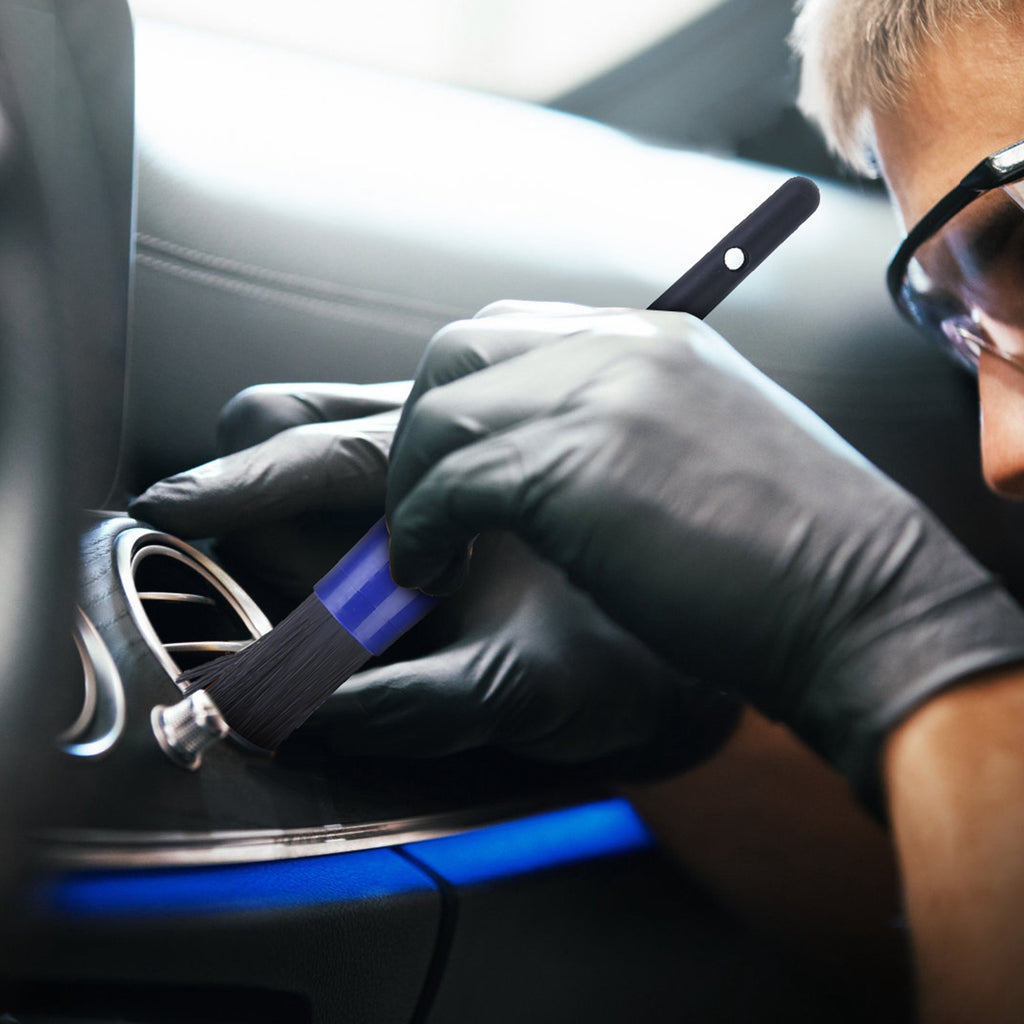 Detailing brush cleaning a car air vent