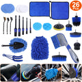 Complete 26-piece car detailing brush kit laid out, blue and black brushes, pads, towels, and wash mitt