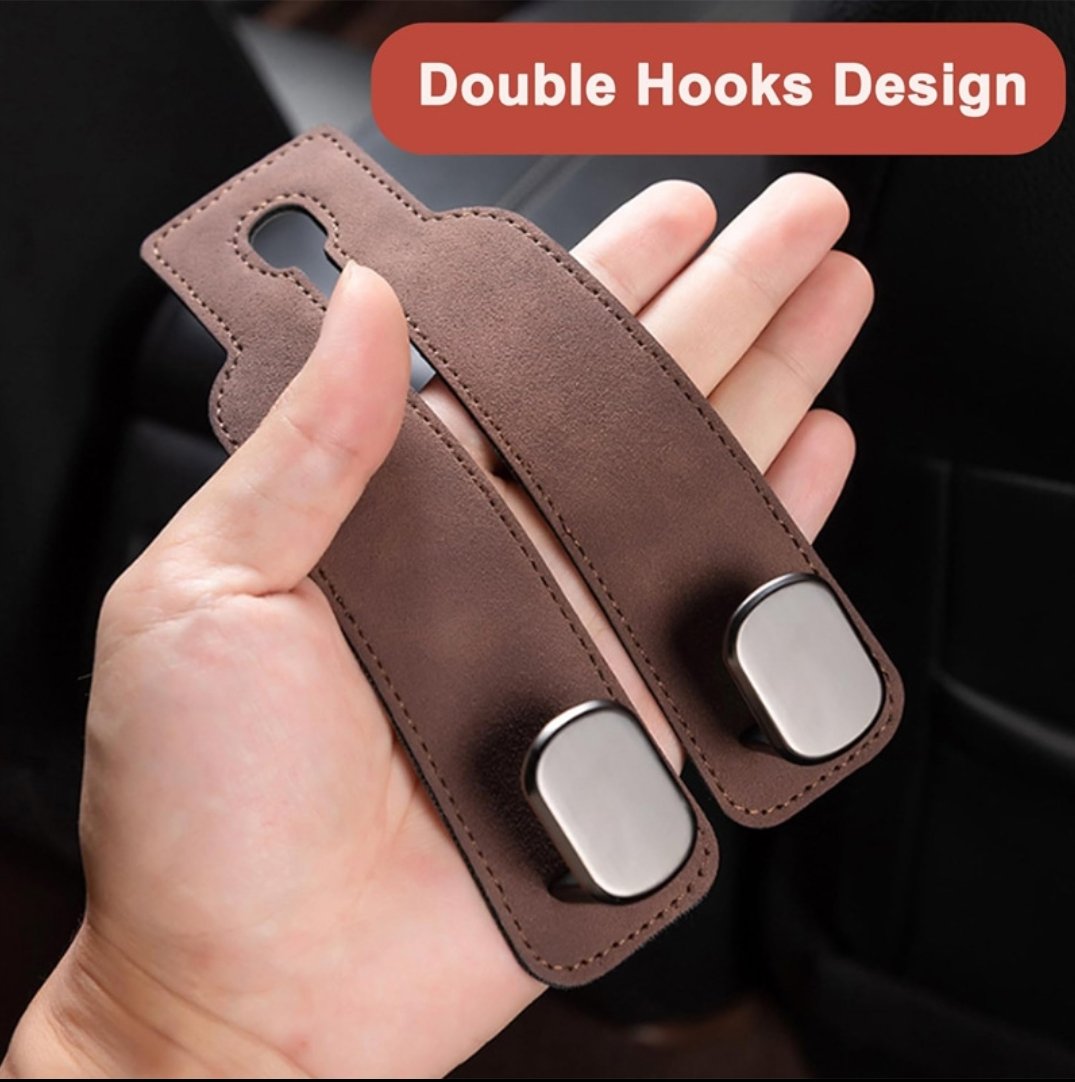 Hand holding one brown suede-look leather hook unit, showing the double hooks design with two metal hook plates