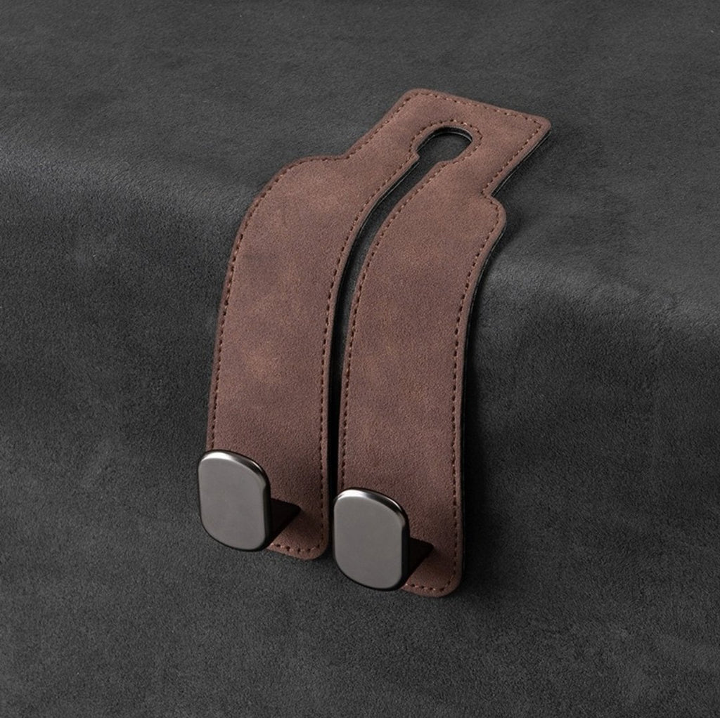 One brown suede-look leather double-hook unit laid flat on dark fabric