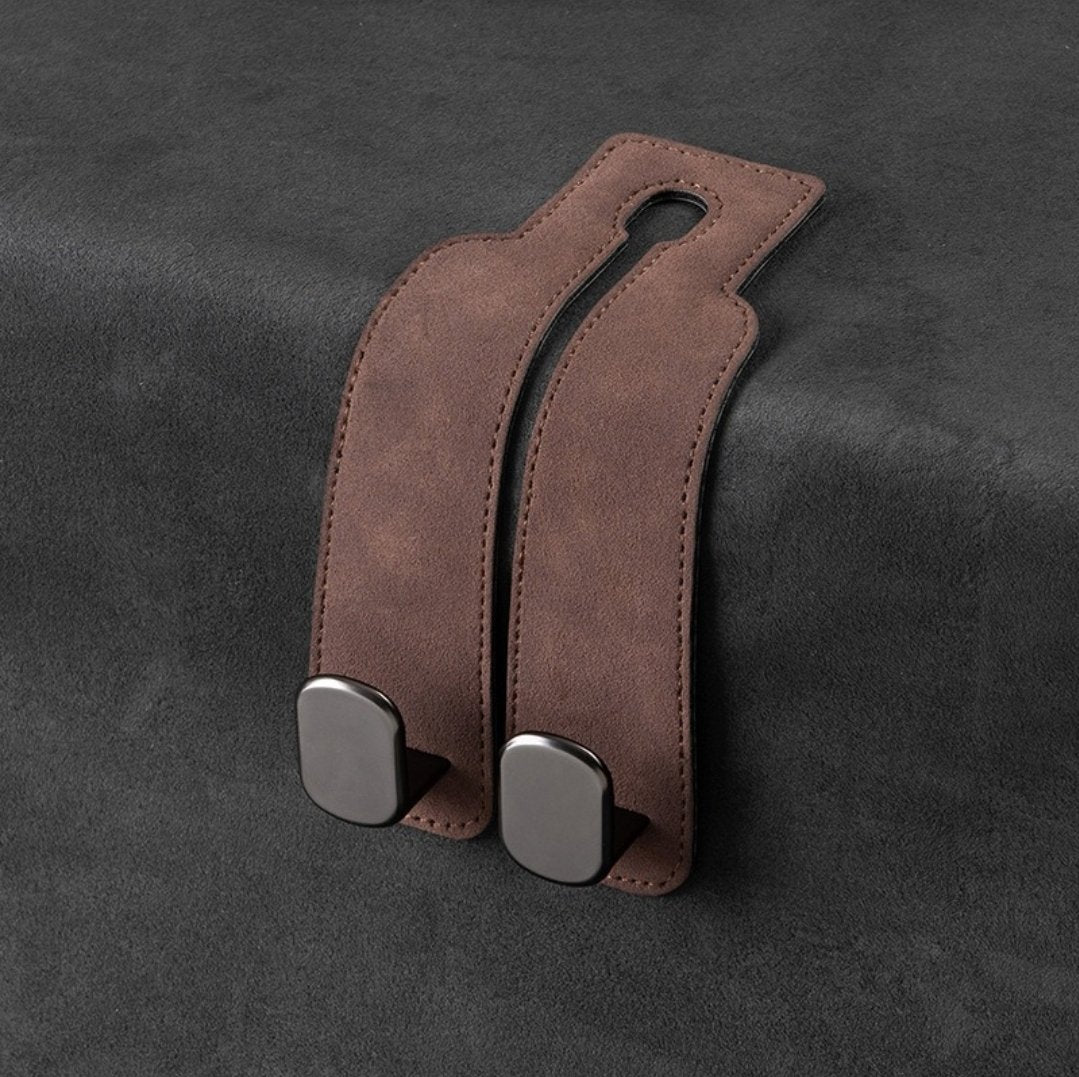 One brown suede-look leather double-hook unit laid flat on dark fabric