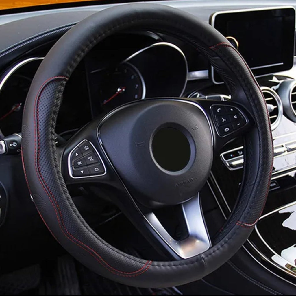 Black fiber leather steering wheel cover with red stitching installed on a car steering wheel